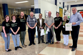 nine brookfield high school students and staff members posing in BFCF teeshirts