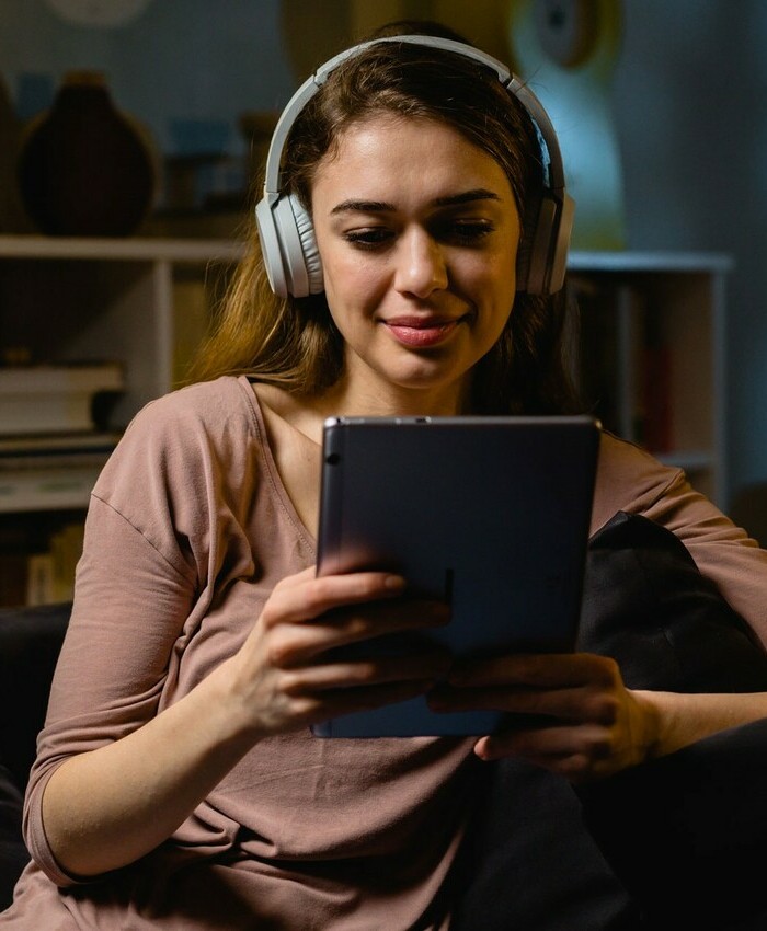 virtual night school student using tablet and headphones